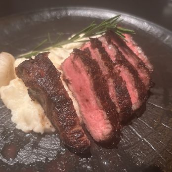 RO Steakhouse - NY strip over potatoes - Steakhouses Near Me - Coral Gables, Florida RO Steakhouse - NY strip over potatoes - Steakhouses Near Me - Coral Gables, Florida