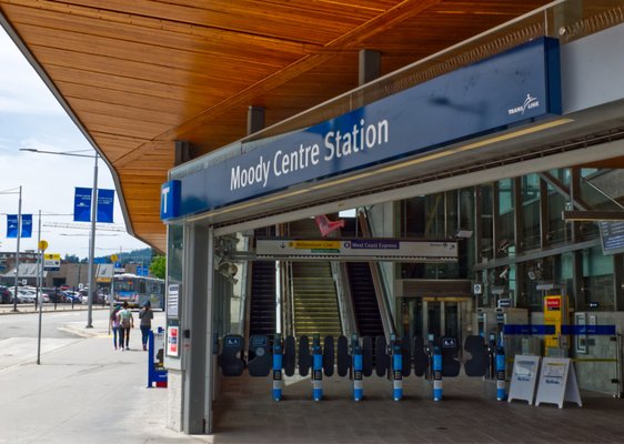  West Coast Express train at Moody Centre Station with mountains in the background