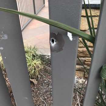 Legacy North Apartments - Bullet hole in metal gate Edna Ct - Apartments Near Me - Plano, Texas