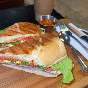 Achilles Art Cafe - Achilles sandwich and a seasonal iced caramel apple latte. - Coffee & Tea Near Me - Orlando, Florida Achilles Art Cafe - Achilles sandwich and a seasonal iced caramel apple latte. - Coffee & Tea Near Me - Orlando, Florida