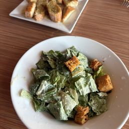 Caesar salad and garlic bread. It came with the dinner. Caesar salad and garlic bread. It came with the dinner.