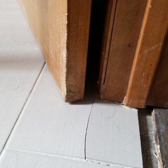 Remodeling & Construction Moran - Cracked tile left. The joint is not centered in the door way as the new contractor pointed out for both doorways - General Contractors Near Me Remodeling & Construction Moran - Cracked tile left. The joint is not centered in the door way as the new contractor pointed out for both doorways - General Contractors Near Me