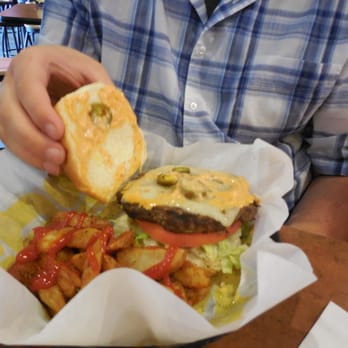 Buffalo Wild Wings - a man eating a hamburger and fries - American Near Me - Cross Lanes, West Virginia