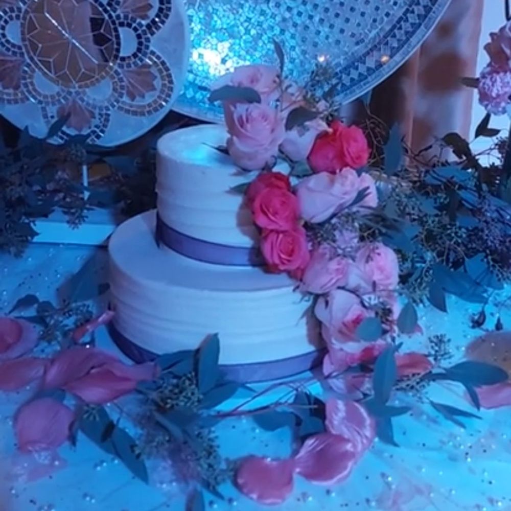 a white wedding cake with pink roses a white wedding cake with pink roses