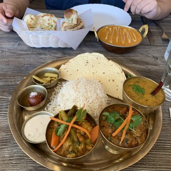 Aama's Kitchen - Nepali Thali - Chicken and Chicken Tikka Masala in the back with Garlic Cilantro Naan - Himalayan/Nepalese Near Me - Hayward, California Aama's Kitchen - Nepali Thali - Chicken and Chicken Tikka Masala in the back with Garlic Cilantro Naan - Himalayan/Nepalese Near Me - Hayward, California