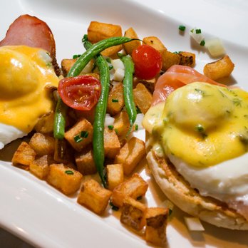 Canoe - Fried Green Tomato Eggs Benedict on the left; Smoked Salmon Eggs Benedict on the right - New American Near Me - Atlanta, Georgia