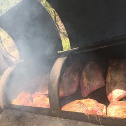 Austin Barbecue Company Catering - Briskets smoking over oak logs on my big pit; my record for most briskets on one smoker is 42; cows and pigs are nervous around me.