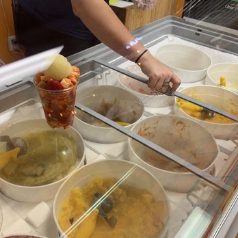 Frulados - a woman preparing food in a restaurant - Shaved Ice Near Me - Margate, Florida