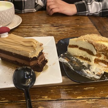 Chateau De Chantilly Cafe - Left: Arabica Cake Right: Biscoff Tiramisu - Bakeries Near Me - Chantilly, Virginia Chateau De Chantilly Cafe - Left: Arabica Cake Right: Biscoff Tiramisu - Bakeries Near Me - Chantilly, Virginia