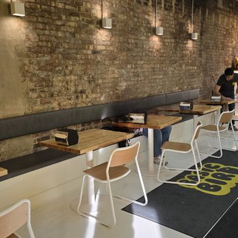 Basic Bird - the interior of a restaurant with tables and benches - Korean Near Me - Des Moines, Iowa