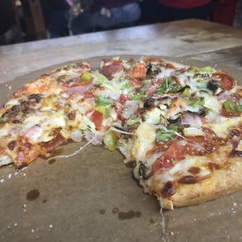 Scores Pizza & Wings - Scores variety 10 inch pizza with one piece already being consumed. - Sports Bars Near Me - Belton, Texas