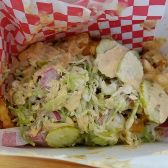 Howlin' Ray's - Mario Fries (secret menu item) has cheese, pickles, and coleslaw on top of the fries and chicken - Southern Near Me - Los Angeles, California