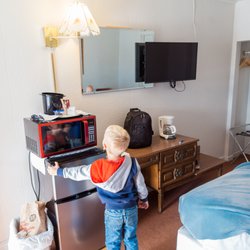 Hacienda Motel - Kid looking at microwave in Room 14