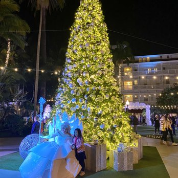 Hotel del Coronado, Curio Collection by Hilton - A couple princesses in front of the outdoor Christmas tree in the Winter Wonderland area of Hotel del Coronado during the holidays - Coronado, CA