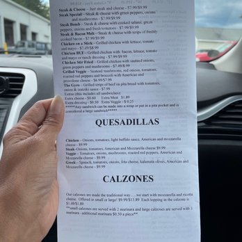 Basil’s - a hand holding a menu in a car - Pizza Near Me - Farmington, Maine Basil’s - a hand holding a menu in a car - Pizza Near Me - Farmington, Maine