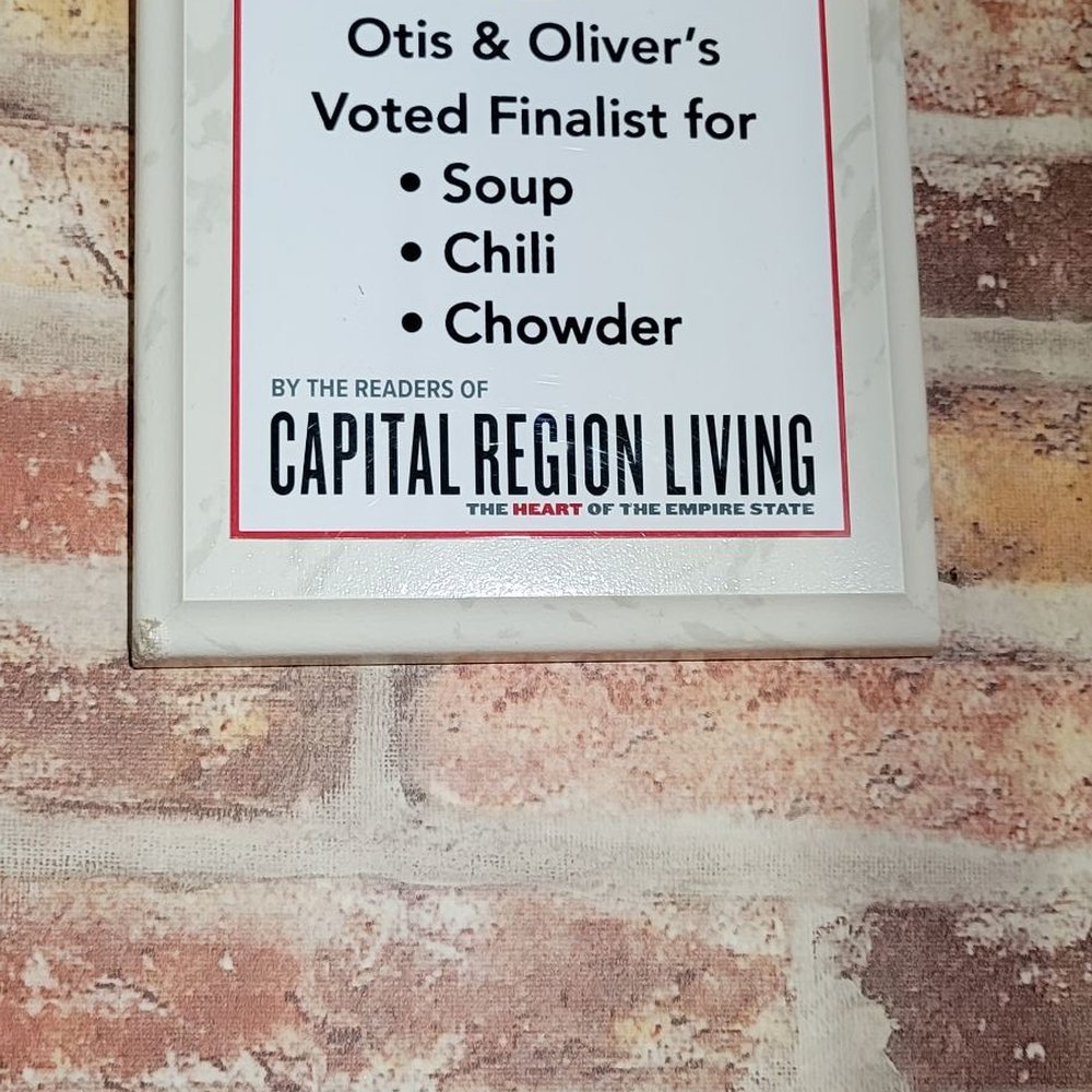 Otis & Oliver's - a sign on a brick wall - New American Near Me - Latham, New York