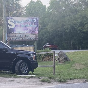 Stumpknockers On The River - From the parking lot their sign and street view - Seafood Near Me - Dunnellon, Florida Stumpknockers On The River - From the parking lot their sign and street view - Seafood Near Me - Dunnellon, Florida