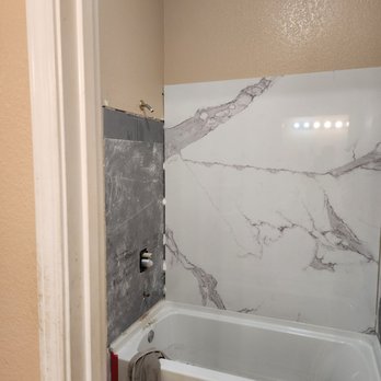 Reseal Marble - a bathtub and shower in a bathroom - General Contractors Near Me Reseal Marble - a bathtub and shower in a bathroom - General Contractors Near Me