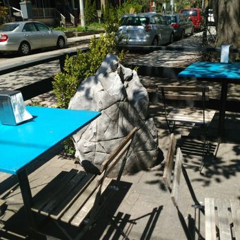 Completo - Patio with several small square tables and 2 picnic tables. - Latin American Near Me - Toronto, Ontario Completo - Patio with several small square tables and 2 picnic tables. - Latin American Near Me - Toronto, Ontario