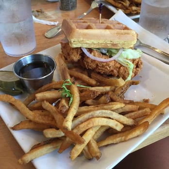 Dogfish Head Brewings & Eats - Buttermilk Belgian Waffles and Fried Chicken Sandwich with a side of Sriracha Maple Syrup and French Fries - American Near Me - Rehoboth Beach, Delaware