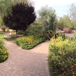 Crossroads Adult Care Home - A panoramic shot of lush and welcoming gardens and flowing water that all three buildings share.