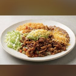 Carnitas plate with guacamole, rice, and beans