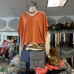 Rock It Resell - Stay cozy and on-trend in this relaxed orange V-neck tunic, styled with chunky leopard-print sneakers.