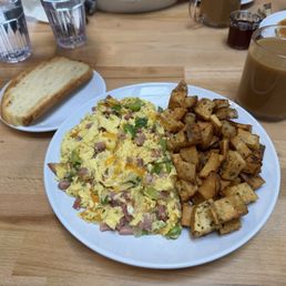 Ham and cheese plus green pepper scrambler with homestyle potatoes and sour dough.