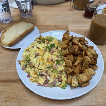 The Olive Brunch Restaurant and Cafe - Ham and cheese plus green pepper scrambler with homestyle potatoes and sour dough. - Mediterranean Near Me - Niles, Illinois