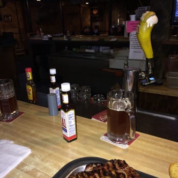 The Brunswick - a steak on a plate with a glass of beer - Bars Near Me - Othello, Washington
