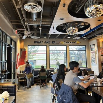 Raising Cane's Chicken Fingers - people sitting at tables in a restaurant - Fast Food Near Me - Columbia, Maryland Raising Cane's Chicken Fingers - people sitting at tables in a restaurant - Fast Food Near Me - Columbia, Maryland