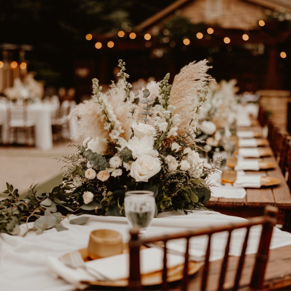 Dinner table with flower arrangements Dinner table with flower arrangements