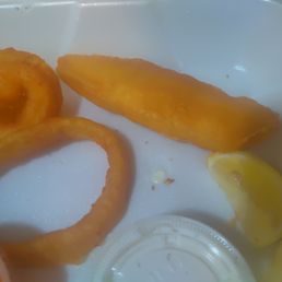 a plate of food with onion rings and ketchup