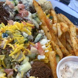 Fries, falafel bowl with saffron rice, tomato, cucumber, garlic Parmesan sauce, with feta amd hummus.