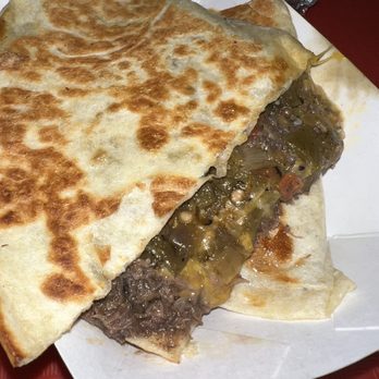 Barbacoa El Primo - Best quesadilla in Albuquerque - A quesadilla filled with beef, vegetables, and melted cheese, served in a paper tray at a casual eatery. - Mexican Near Me - Albuquerque, New Mexico