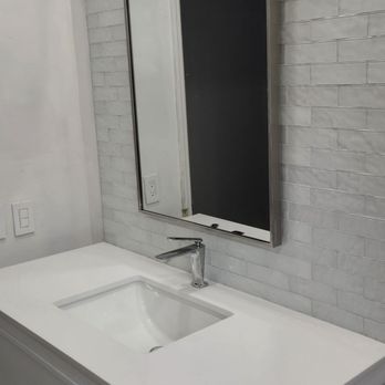 Lopez Flooring and More - New vanity with glass tile wall and vanity light - Flooring Near Me