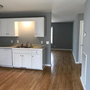 Forever Flooring - a kitchen with white cabinets and wood floors - Flooring Near Me Forever Flooring - a kitchen with white cabinets and wood floors - Flooring Near Me