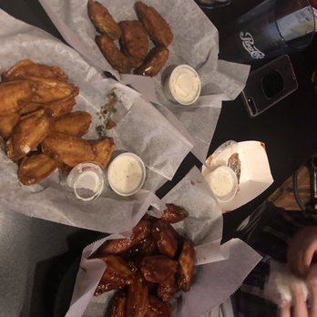 Scuba's Pourhouse - Scuba's Pourhouse. Left wings are the super hot wings. I love hot, these are crazy hot,yet edible. Wings on the right are Korean Barbecue. - Pubs Near Me - Appleton, Wisconsin