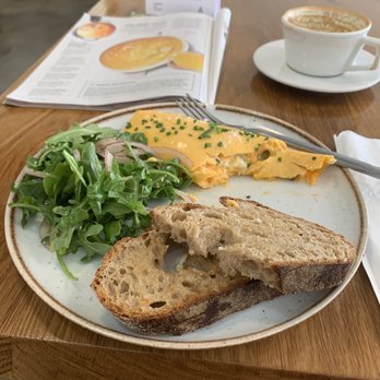 The Bakehouse - French Boursin with caramelized leeks omelette with arugula salad and sourdough toast along with cappuccino. - Bakeries Near Me - Riverside, California The Bakehouse - French Boursin with caramelized leeks omelette with arugula salad and sourdough toast along with cappuccino. - Bakeries Near Me - Riverside, California