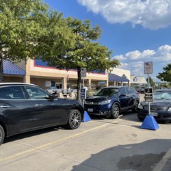 Lowe's Home Improvement - Designated Veteran parking spaces. American flag flying on the front of the store, in the background.