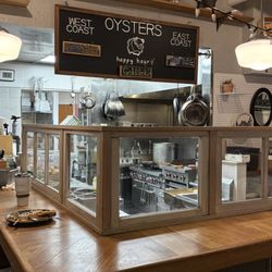 Open kitchen with oyster board: West Coast and East Coast oysters daily