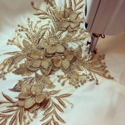 Adding lace appliqué onto the train of a wedding dress