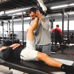 Sandbox Fitness Club - Co-Owner Ryan Cadaret providing a client with a recovery session.
