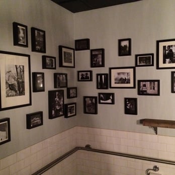Au Comptoir - Lots of pictures hung in the dimly lit washroom - French Near Me - Vancouver, British Columbia Au Comptoir - Lots of pictures hung in the dimly lit washroom - French Near Me - Vancouver, British Columbia