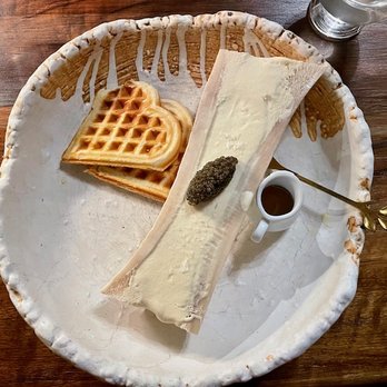 Sauvage Restaurant - "Straight & Marrow".  This is a yolk & marrow ice cream served with fois gras waffles and maple syrup - Canadian (New) Near Me - Canmore, Alberta