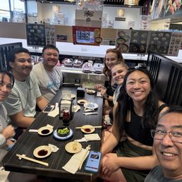 Eight people on a small table but we made it work. We were all smiles ever though we were waiting for food on the conveyor belt. Eight people on a small table but we made it work. We were all smiles ever though we were waiting for food on the conveyor belt.