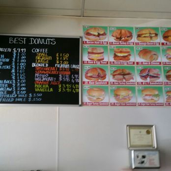 Best Donuts - Menu of donuts/drinks on chalkboard mounted on wall behind counter + photos of all their sandwiches. - Donuts Near Me - San Ramon, California
