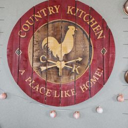 a wooden sign with a rooster on it a wooden sign with a rooster on it