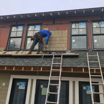 BREL Services - two men working on a roof - Roofing Near Me BREL Services - two men working on a roof - Roofing Near Me