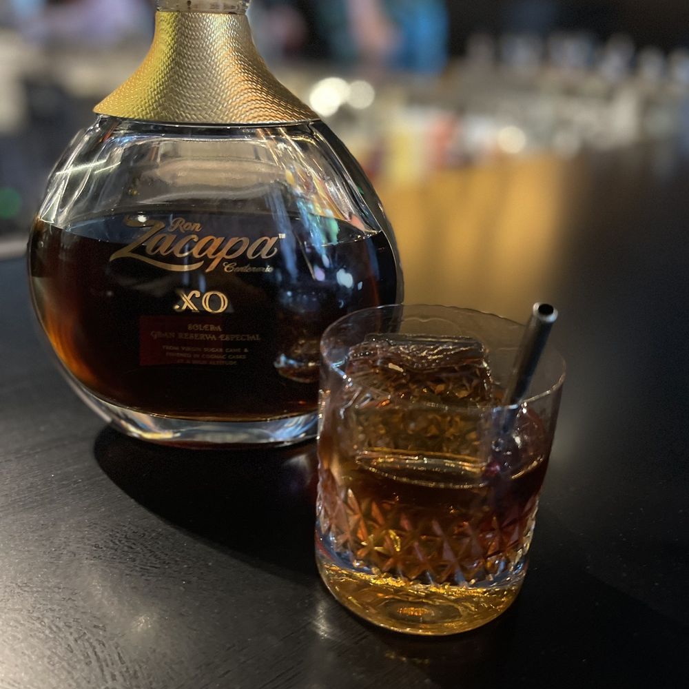 Provision - a glass of whiskey and a decanter on a table - Cocktail Bars Near Me - Castle Rock, Colorado Provision - a glass of whiskey and a decanter on a table - Cocktail Bars Near Me - Castle Rock, Colorado